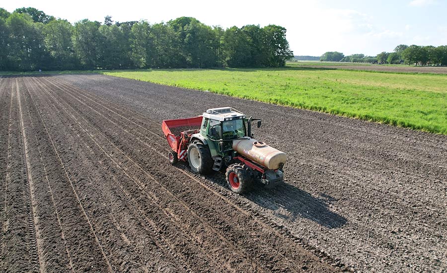 Tractor equipped with auto-steering system operating in a cultivated field