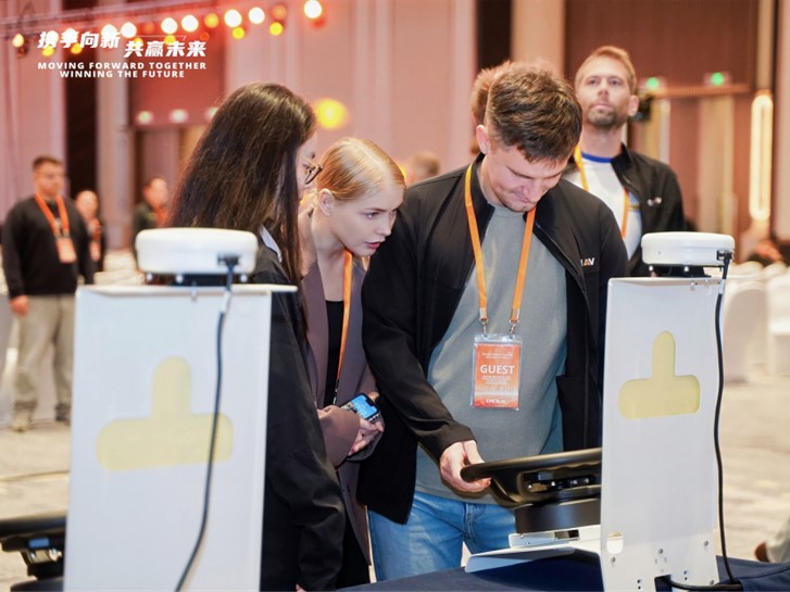 Conference visitors examine the Agricultural Systems during a product demonstration.